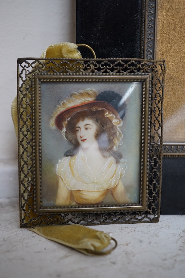 Two 19th century portrait miniatures on simulated ivory and card, comprising portrait of a Regency lady and portrait of a late Victorian lady in mourning, largest overall 24 x 19cm. Condition - fair